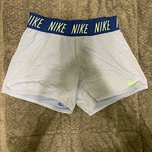 Light blue, mint green, and dark blue Nike shorts